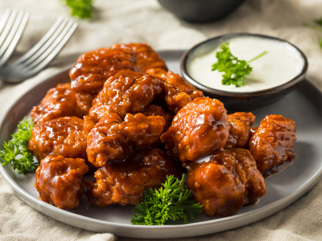 Spicy buffalo wings with creamy ranch dip, served fresh—ideal for promoting hands-on cooking classes in Mokena, Crest Hill, and Chicago. Perfect for food lovers and culinary events.