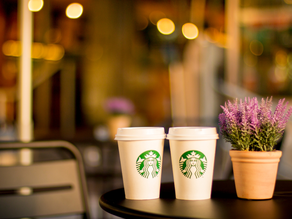 Warm evening coffee moments captured with Starbucks cups on a cozy café table—perfect ambiance for casual meetups near Mokena, Crest Hill, and Chicago