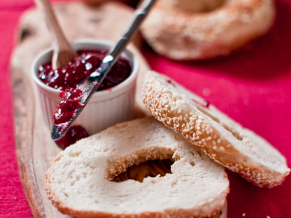 Freshly sliced sesame bagel with berry jam — featured in beginner-friendly cooking classes in Chicago, Crest Hill, and Mokena