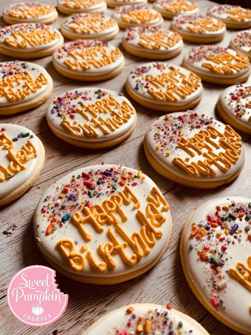 Round sugar cookies decorated with orange 'Happy Birthday' icing and colorful sprinkles, featured in a cookie decorating class in Chicago, Crest Hill, or Mokena