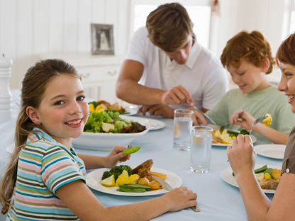 A joyful family enjoys a healthy homemade dinner together—capturing the spirit of connection and the impact of kids cooking classes near Chicago, Crest Hill, and Mokena