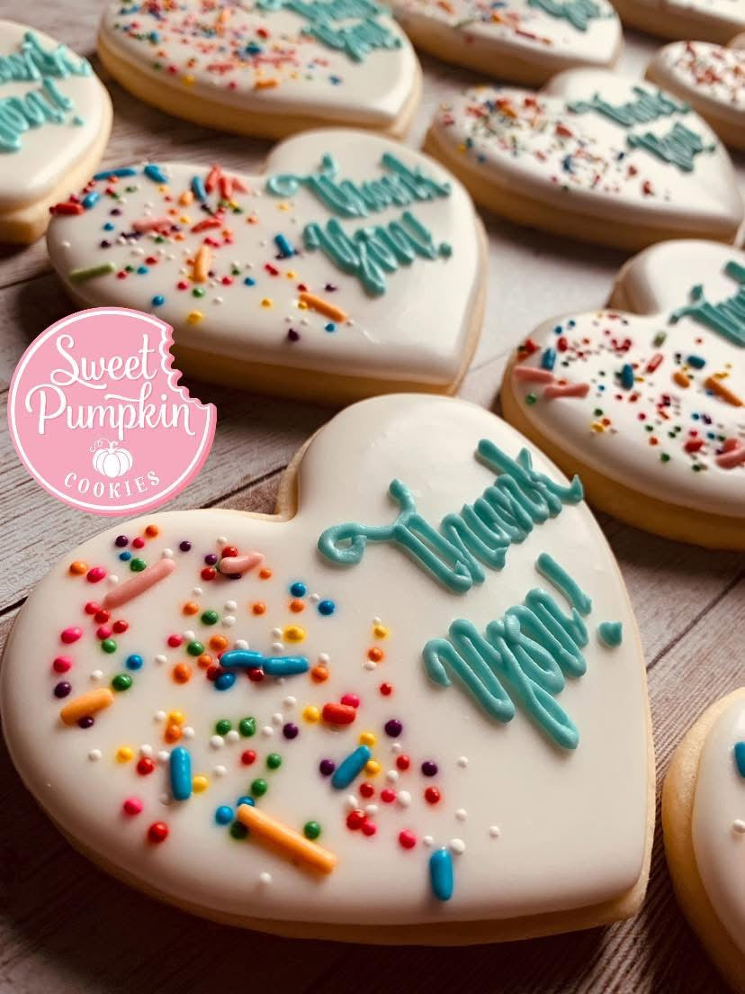 Heart-shaped sugar cookies with teal ‘Thank You’ icing and rainbow sprinkles, created in a cookie decorating class in Chicago, Crest Hill, or Mokena.